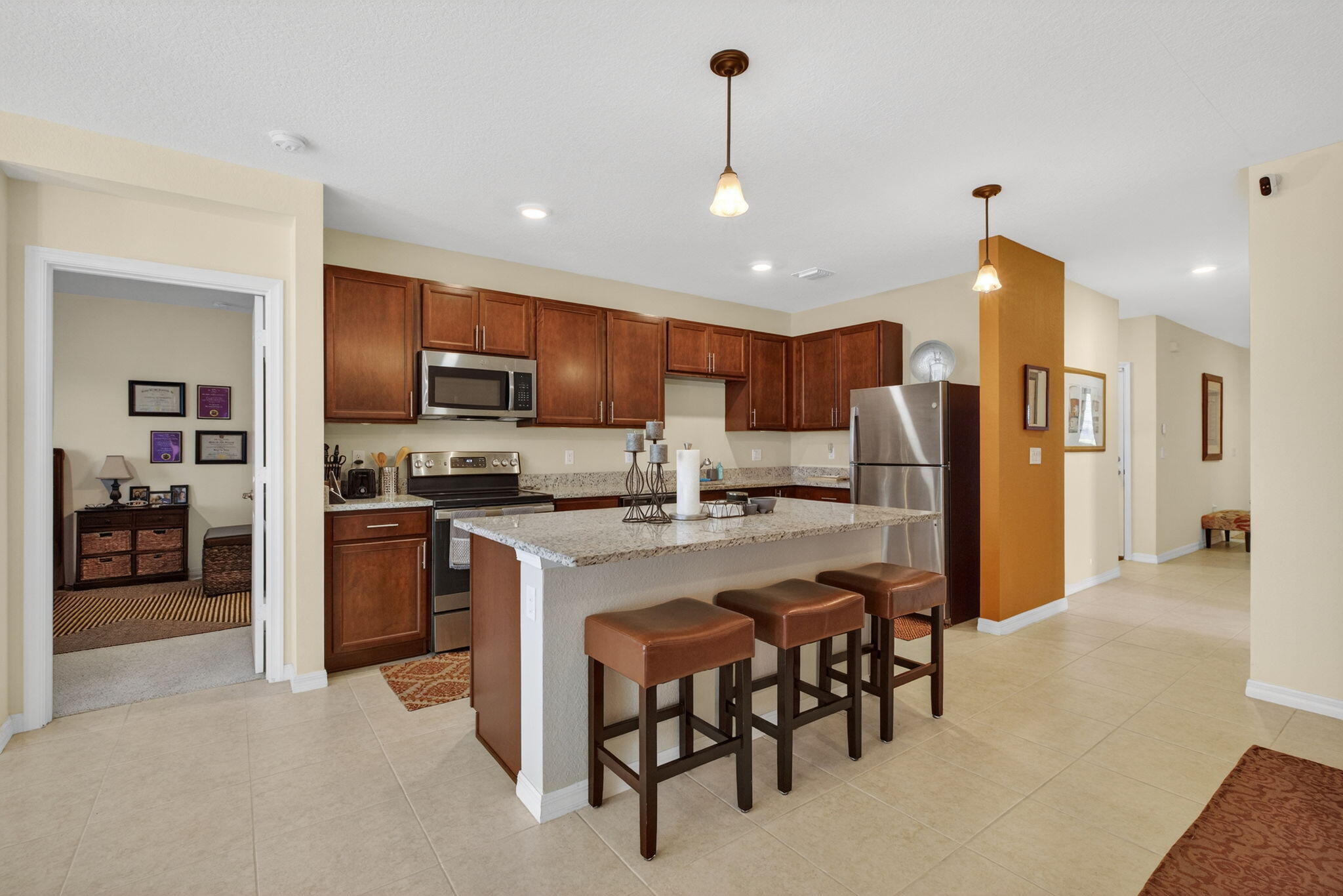 5221 Armina Place Fort Pierce, FL 34951 - Photo 10 of 40 a kitchen with refrigerator and chairs