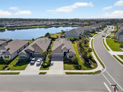 an aerial view of a house with a garden and lake view