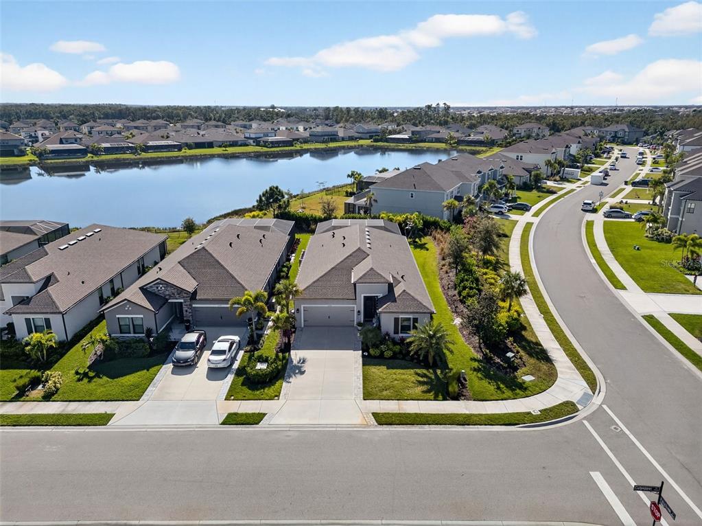 an aerial view of a house with a garden and lake view