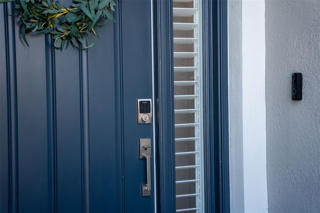 16106 Culpepper Drive Lakewood Ranch, FL 34211 - Photo 13 of 99 a vase of flowers sitting in a bathroom next to a wooden door