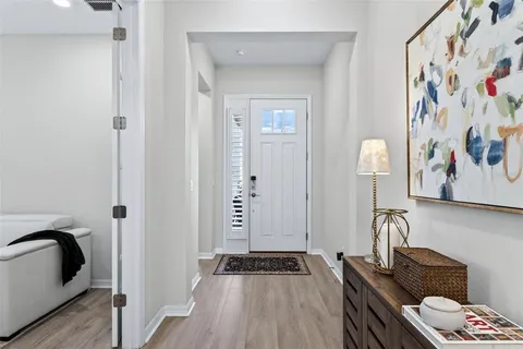 a view of a dining room with furniture and a chandelier