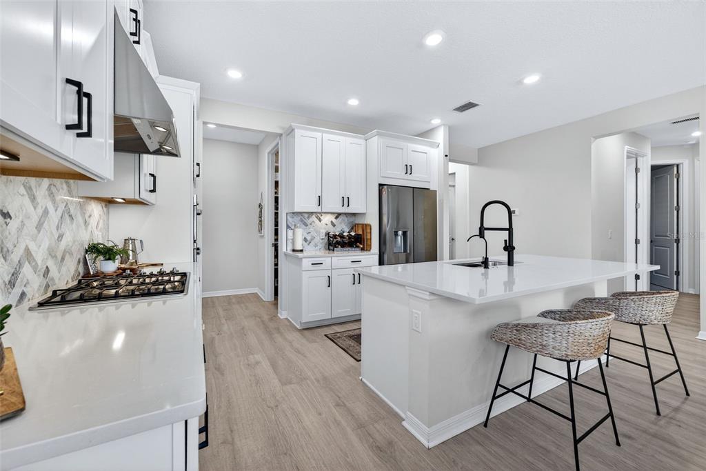 16106 Culpepper Drive Lakewood Ranch, FL 34211 - Photo 28 of 99 a kitchen with white cabinets and stainless steel appliances
