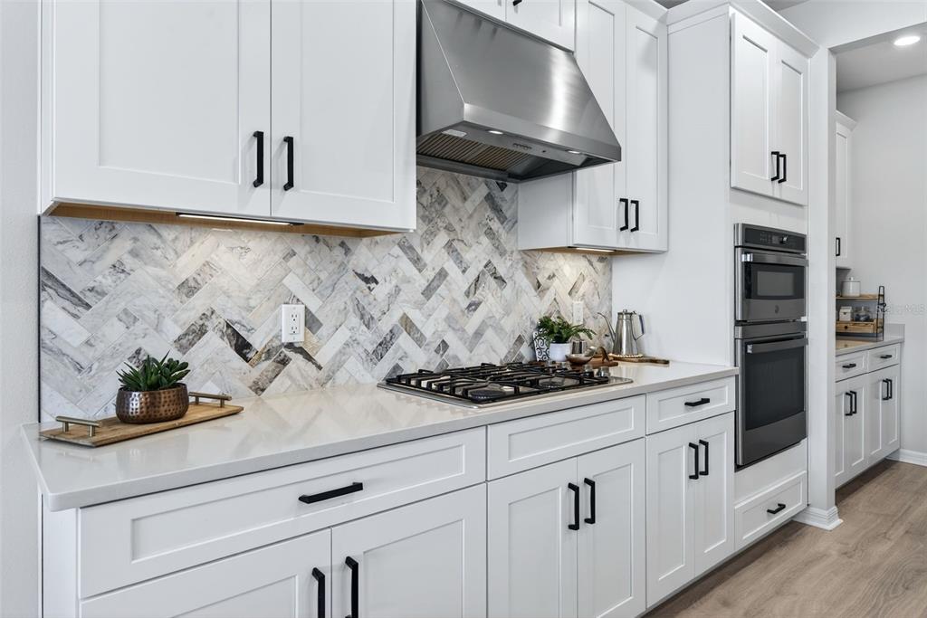 16106 Culpepper Drive Lakewood Ranch, FL 34211 - Photo 30 of 99 a kitchen with white cabinets and a stove