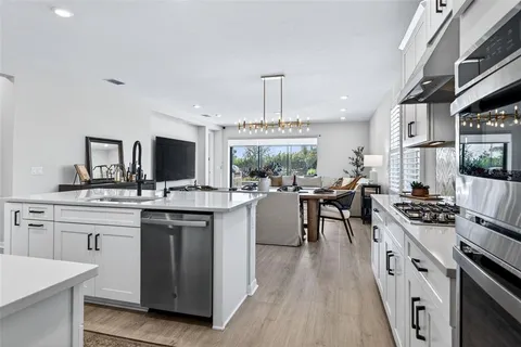 a view of a patio with a table and chairs under an umbrella