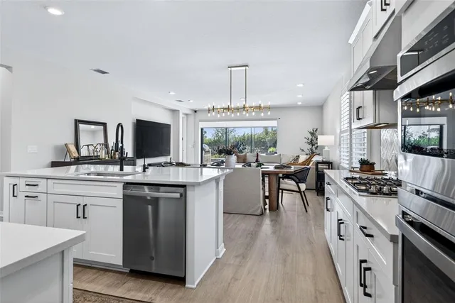 a view of a patio with a table and chairs under an umbrella