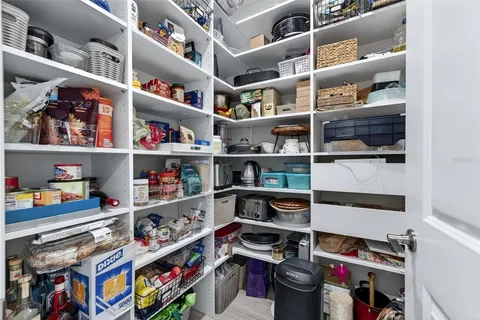 a view of a patio with a table and chairs under an umbrella