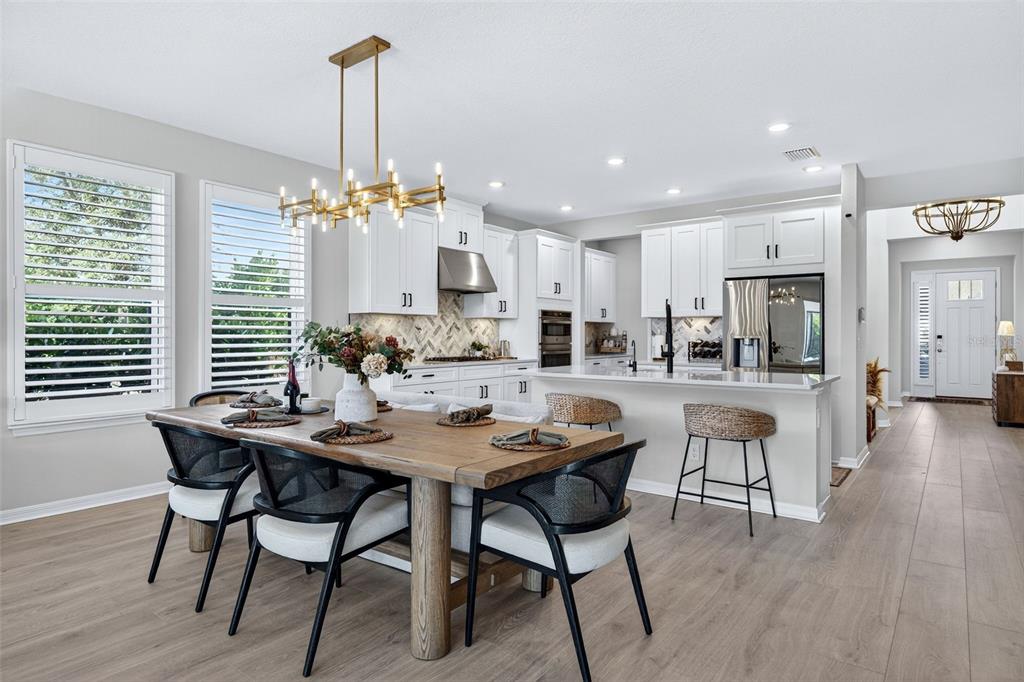 16106 Culpepper Drive Lakewood Ranch, FL 34211 - Photo 40 of 99 a view of a dining room with furniture window and wooden floor