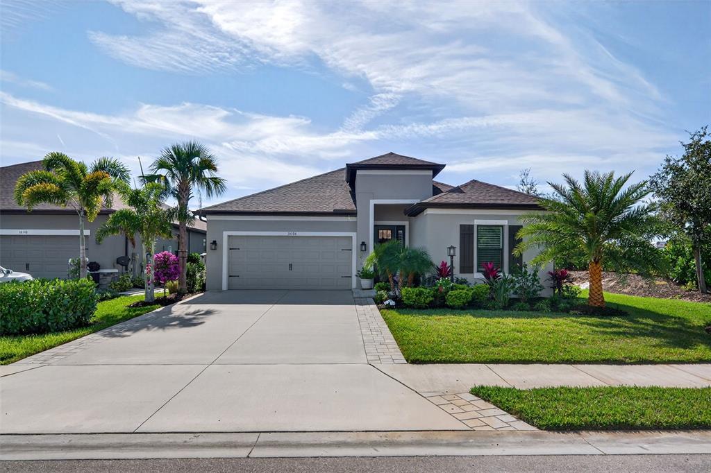 16106 Culpepper Drive Lakewood Ranch, FL 34211 - Photo 5 of 99 a front view of a house with a yard and potted plants