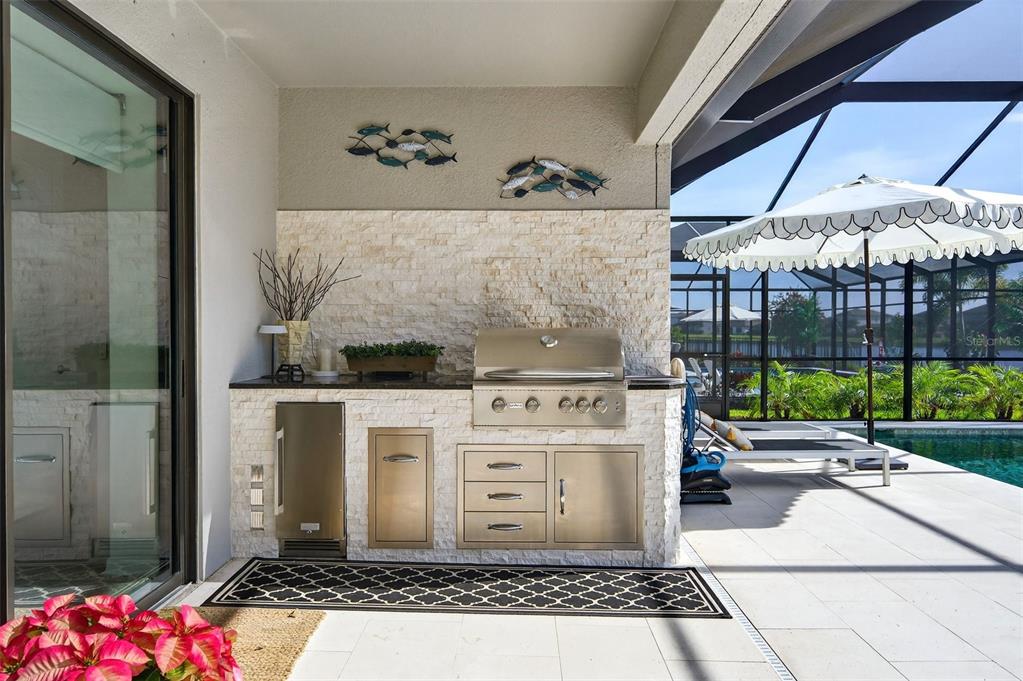 16106 Culpepper Drive Lakewood Ranch, FL 34211 - Photo 53 of 99 a living room with a fireplace furniture and a floor to ceiling window