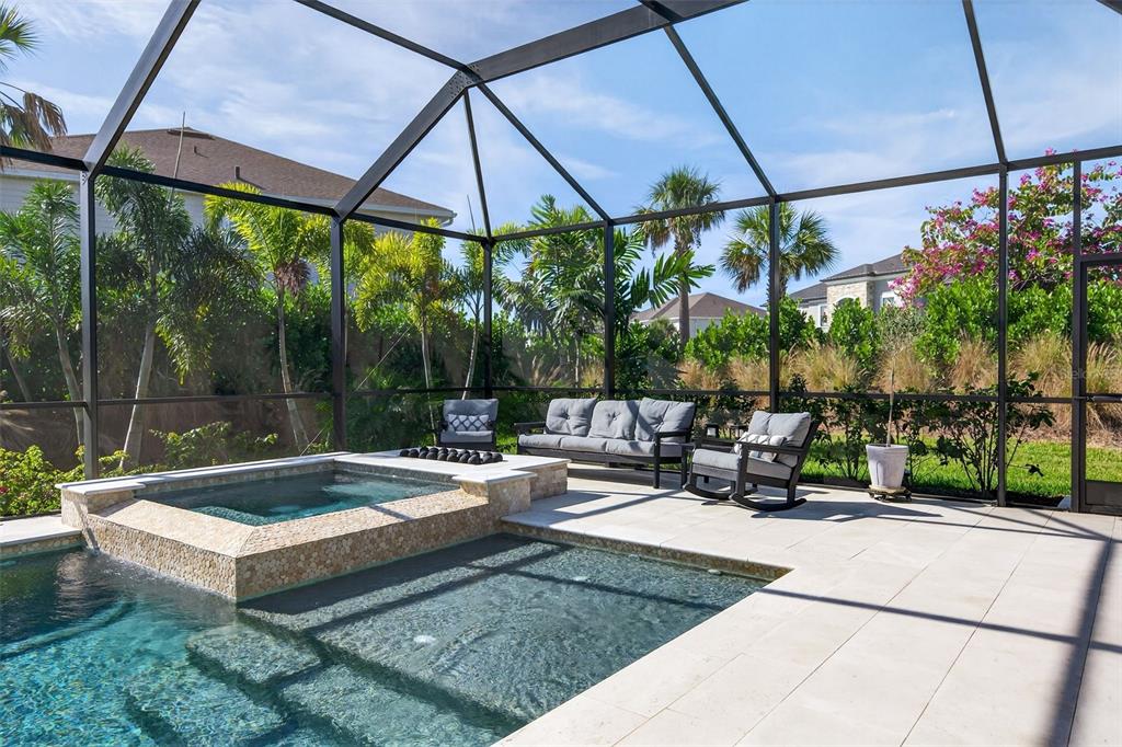 16106 Culpepper Drive Lakewood Ranch, FL 34211 - Photo 57 of 99 a view of a patio with a table and chairs under an umbrella