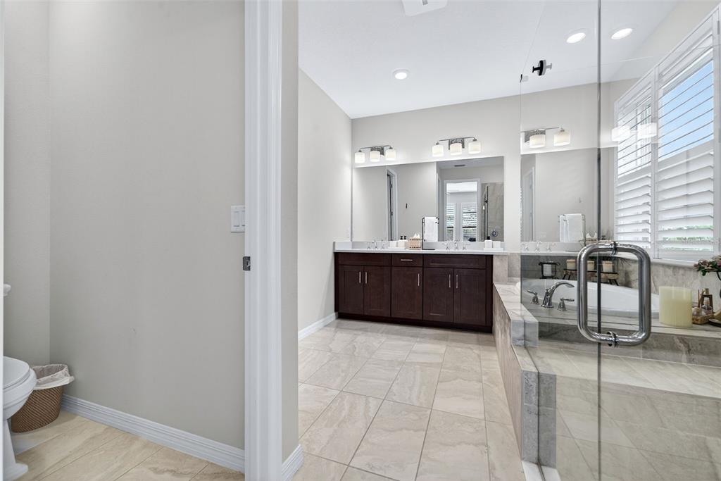 16106 Culpepper Drive Lakewood Ranch, FL 34211 - Photo 76 of 99 a bathroom with a sink a mirror and a toilet