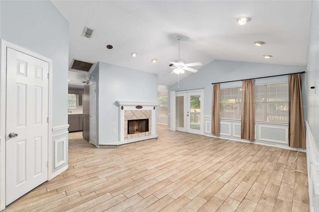 9161 Southwest 34th Place Ocala, FL 34481 - Photo 11 of 100 a view of a livingroom with a fireplace wooden floor and windows