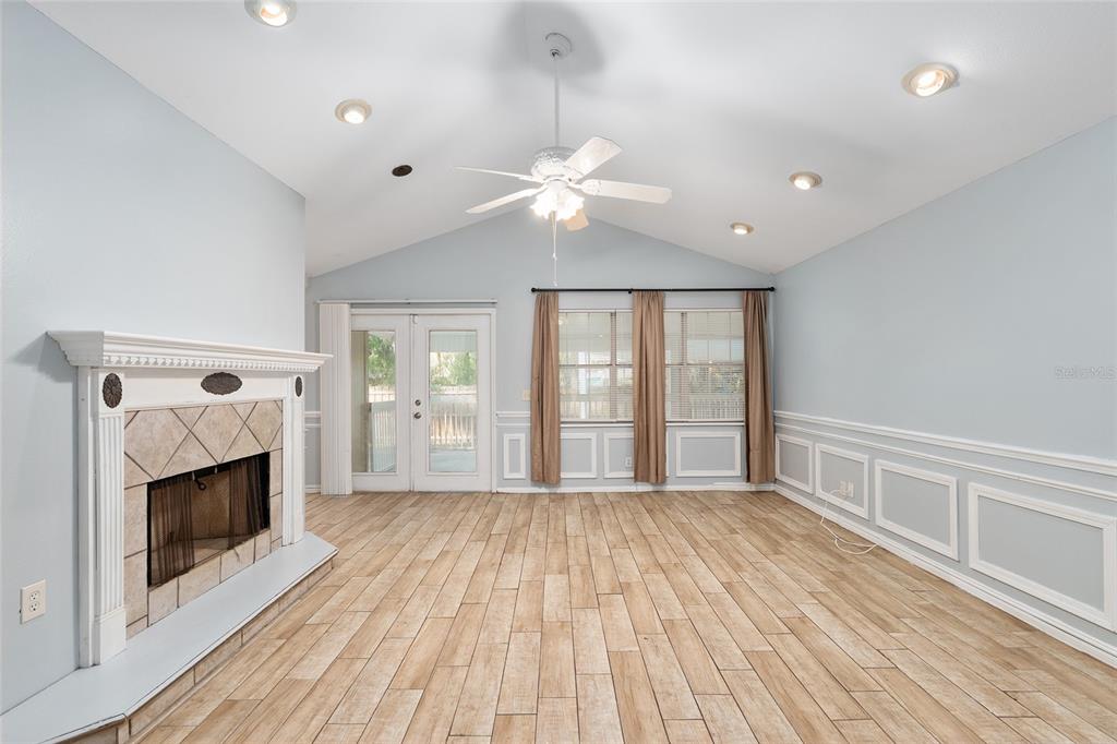 9161 Southwest 34th Place Ocala, FL 34481 - Photo 12 of 100 a view of empty room with wooden floor and fan