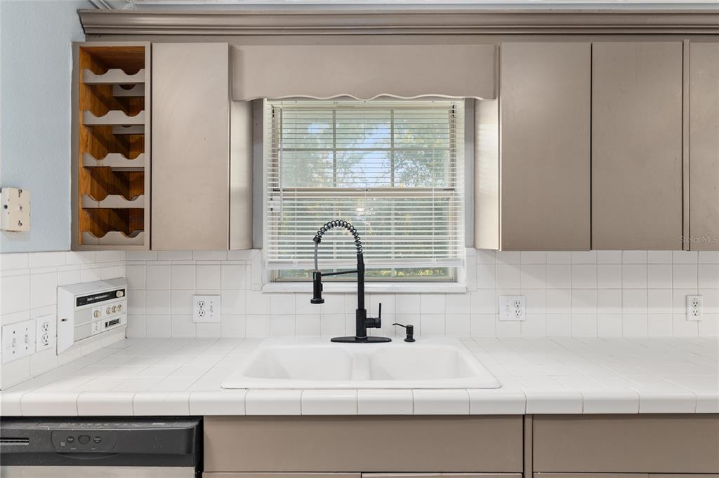 9161 Southwest 34th Place Ocala, FL 34481 - Photo 23 of 100 a bathroom with a sink and a window