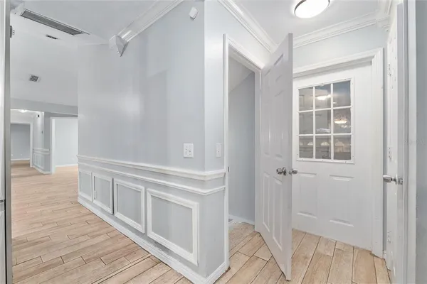a view of a hallway with wooden floor