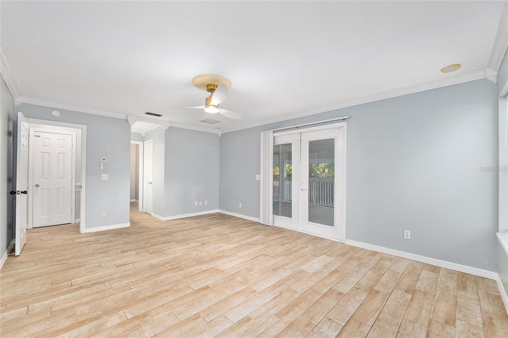 9161 Southwest 34th Place Ocala, FL 34481 - Photo 27 of 100 a view of an empty room with wooden floor and a window
