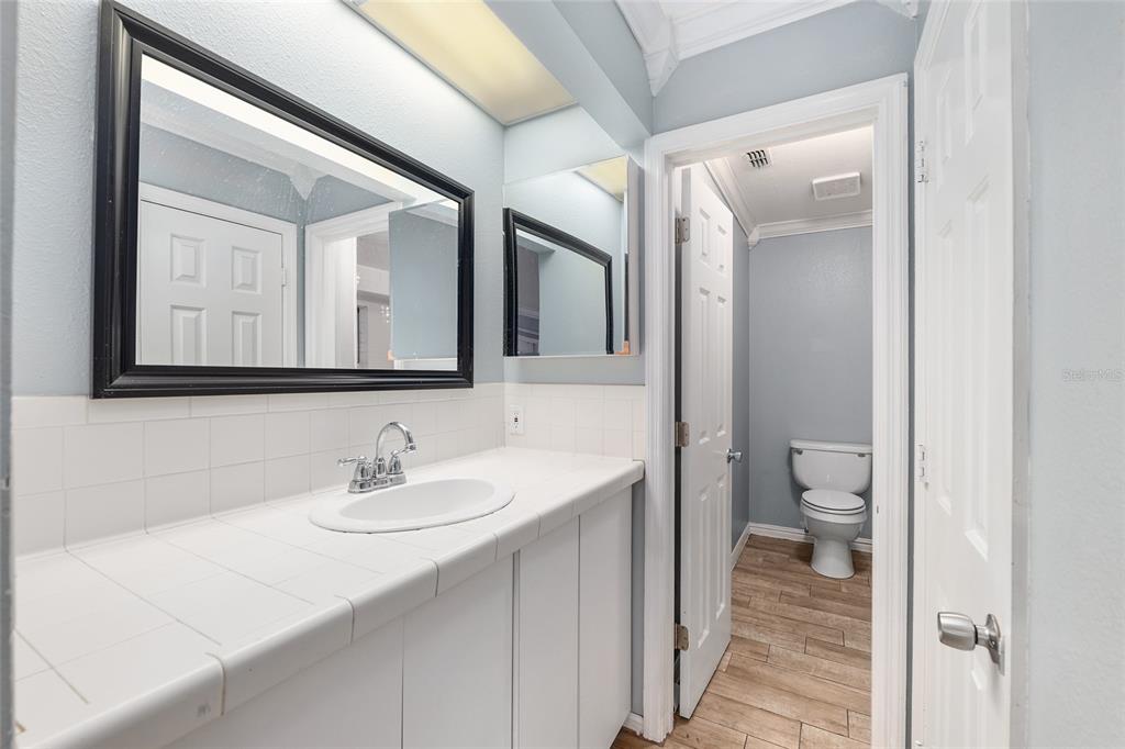9161 Southwest 34th Place Ocala, FL 34481 - Photo 28 of 100 a bathroom with a sink a toilet and a mirror