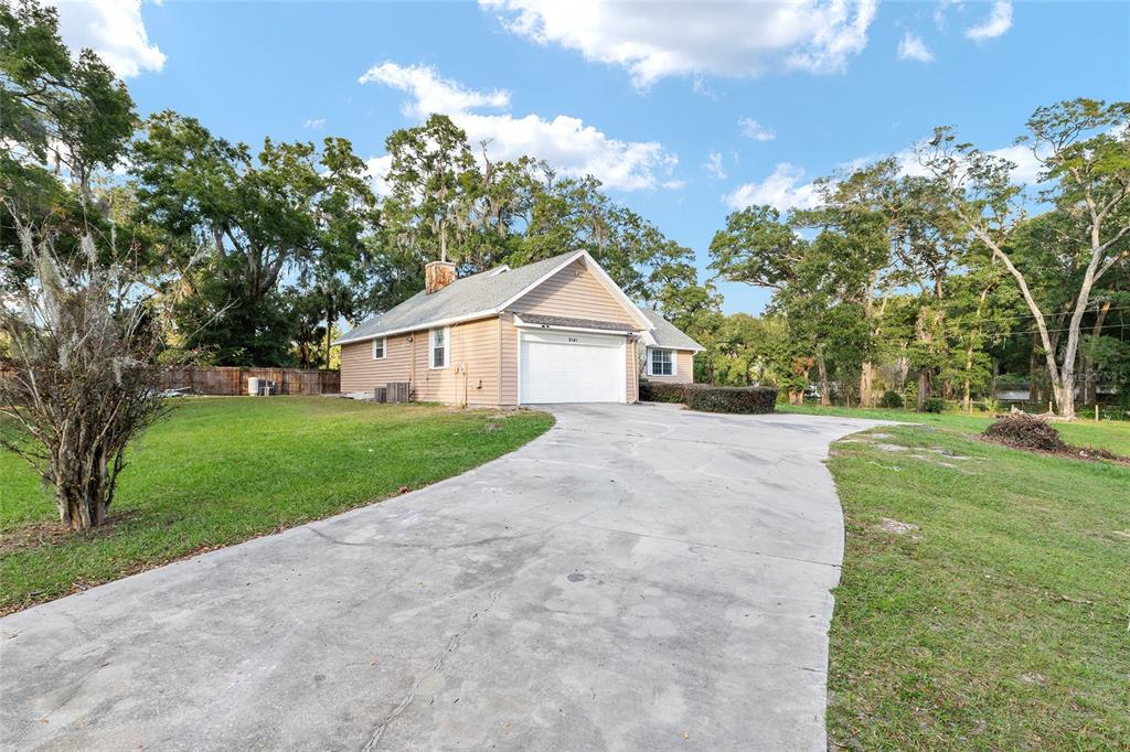 9161 Southwest 34th Place Ocala, FL 34481 - Photo 3 of 100 a view of a house with a yard and large tree