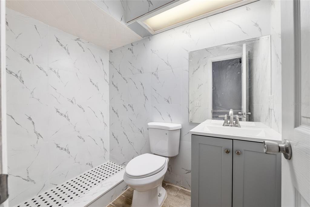 9161 Southwest 34th Place Ocala, FL 34481 - Photo 34 of 100 a bathroom with a sink toilet and mirror