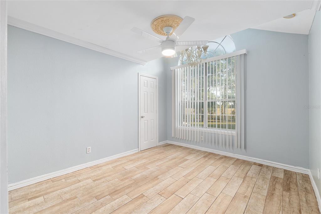 9161 Southwest 34th Place Ocala, FL 34481 - Photo 36 of 100 a view of an empty room with wooden floor and a window