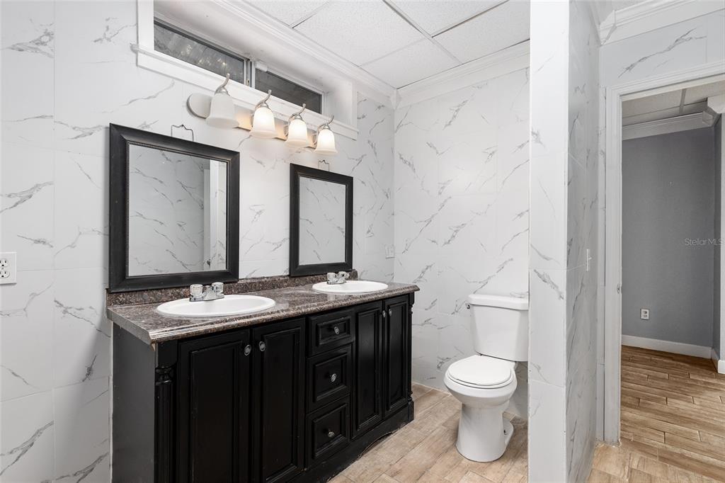 9161 Southwest 34th Place Ocala, FL 34481 - Photo 52 of 100 a bathroom with a granite countertop toilet sink and mirror