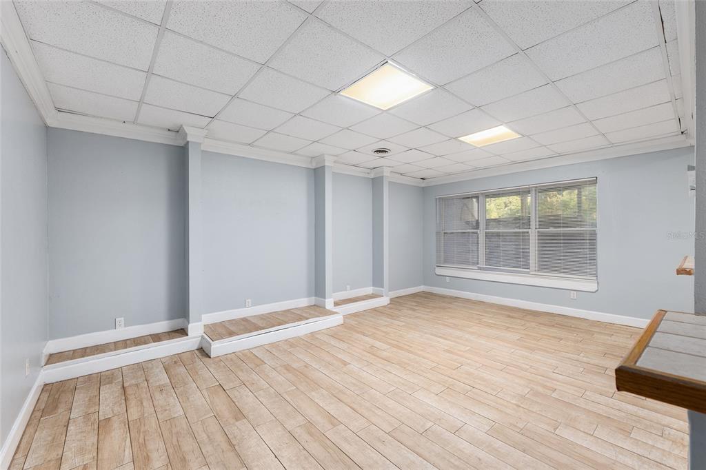9161 Southwest 34th Place Ocala, FL 34481 - Photo 56 of 100 a view of an empty room with wooden floor and a window