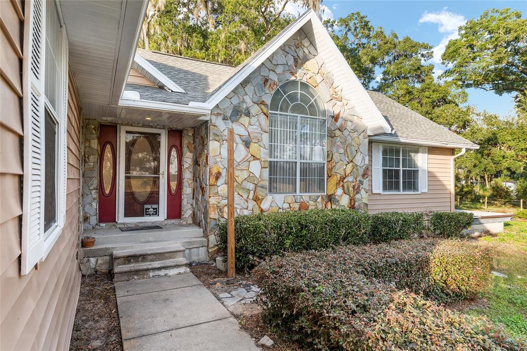 9161 Southwest 34th Place Ocala, FL 34481 - Photo 6 of 100 a front view of a house with a yard