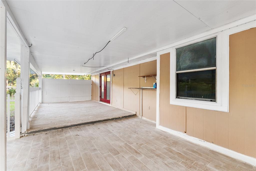 9161 Southwest 34th Place Ocala, FL 34481 - Photo 73 of 100 a view of a hallway with wooden floor and a cabinet
