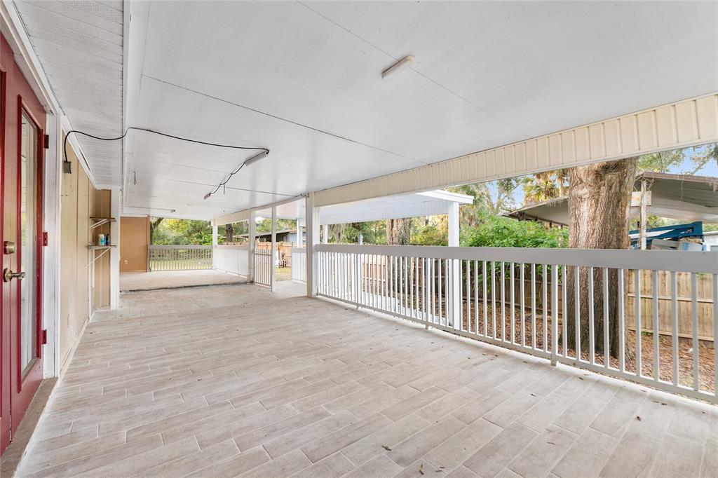 9161 Southwest 34th Place Ocala, FL 34481 - Photo 74 of 100 a view of a porch with wooden floor and outdoor space