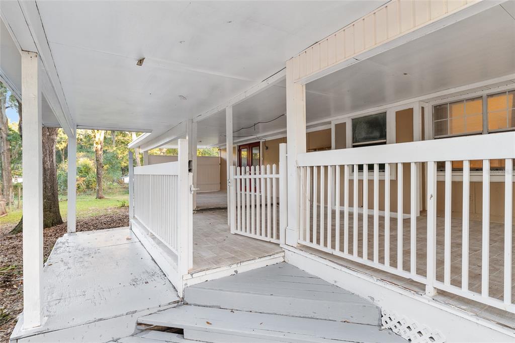 9161 Southwest 34th Place Ocala, FL 34481 - Photo 76 of 100 a view of a house with a small yard and wooden fence