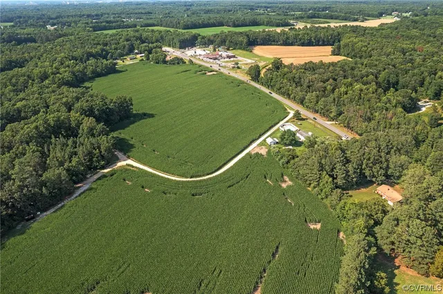 an aerial view of a golf course with a lake view