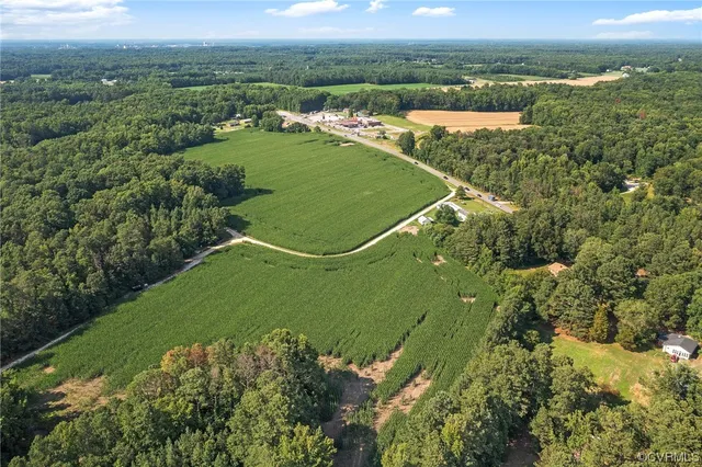 an aerial view of a houses with a yard