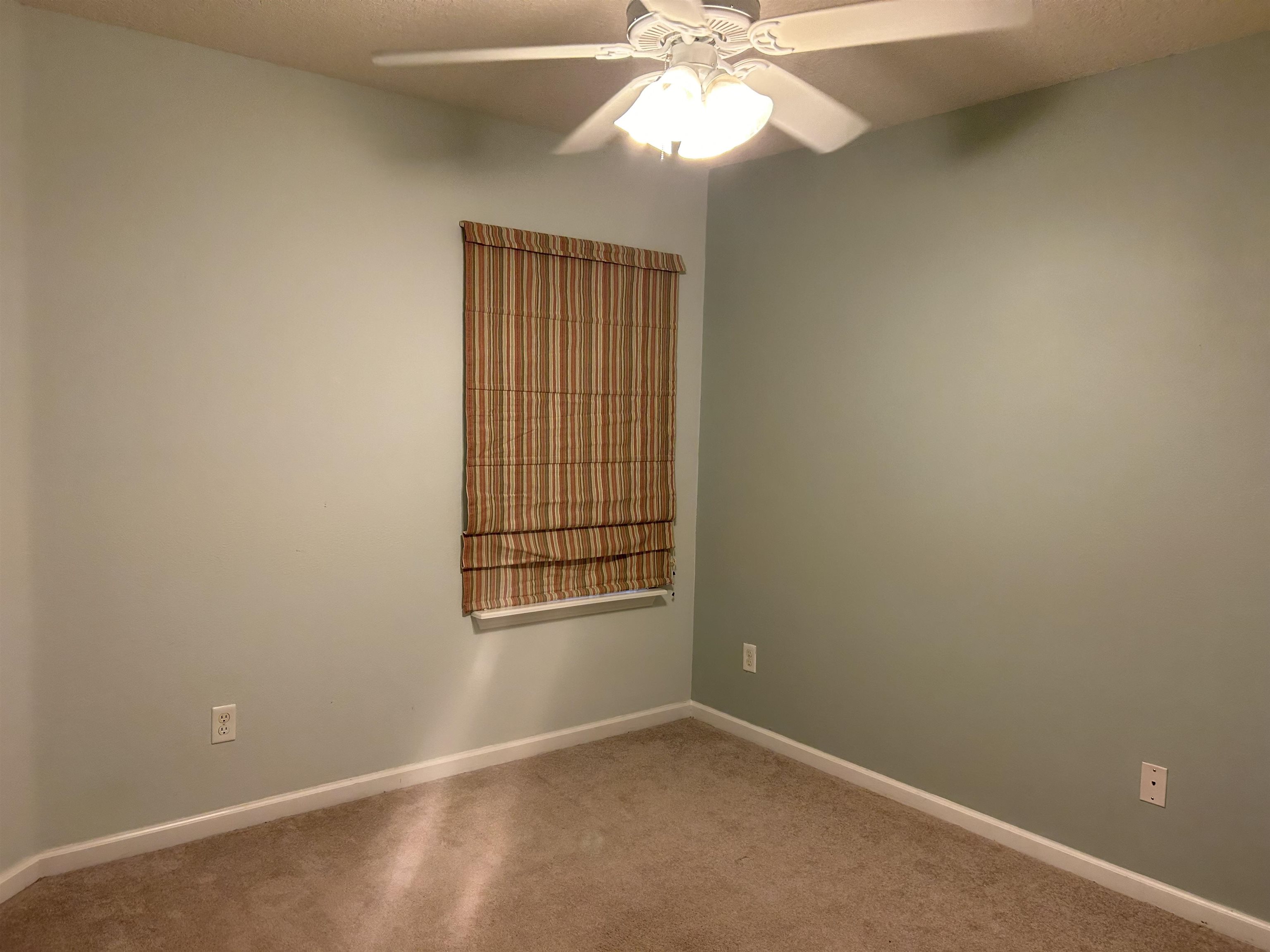 240 Golden Lake Loop St. Augustine, FL 32084 - Photo 12 of 28 an empty room with windows and fan