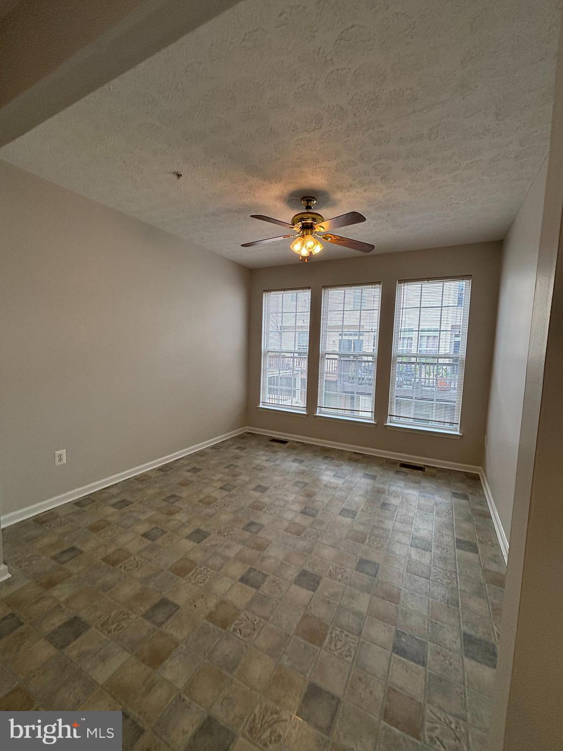 9804 Redwing Drive, Unit 9804 Perry Hall, MD 21128 - Photo 12 of 25 an empty room with windows and ceiling fan