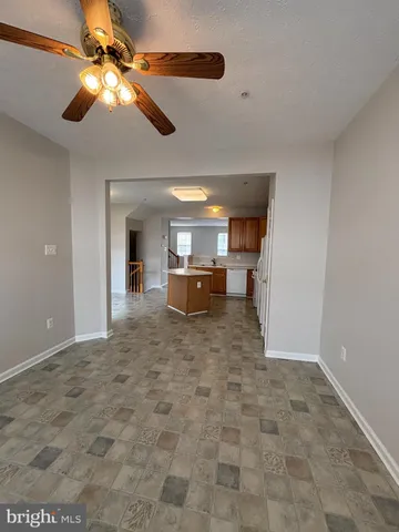a kitchen with sink a refrigerator and cabinets