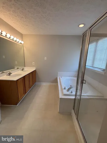 a bathroom with a tub and a shower