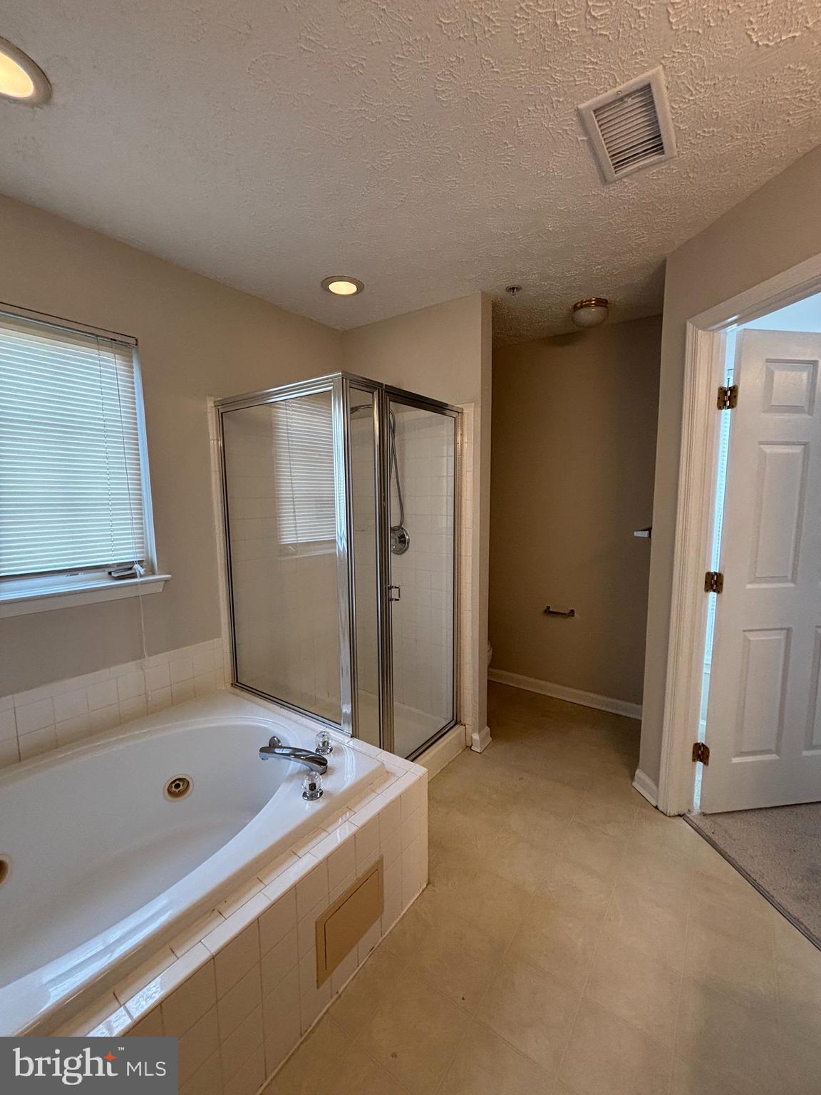 9804 Redwing Drive, Unit 9804 Perry Hall, MD 21128 - Photo 21 of 25 a bathroom with a tub and a shower