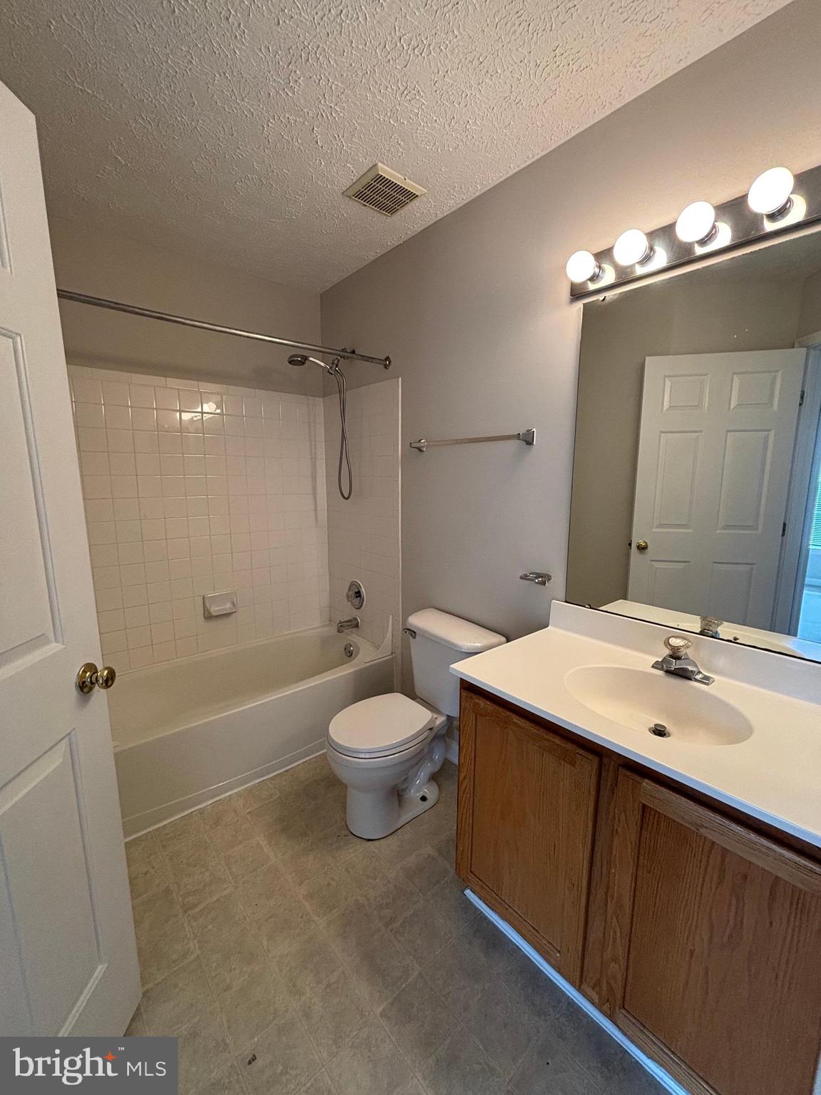 9804 Redwing Drive, Unit 9804 Perry Hall, MD 21128 - Photo 25 of 25 a bathroom with a sink a toilet a mirror and shower