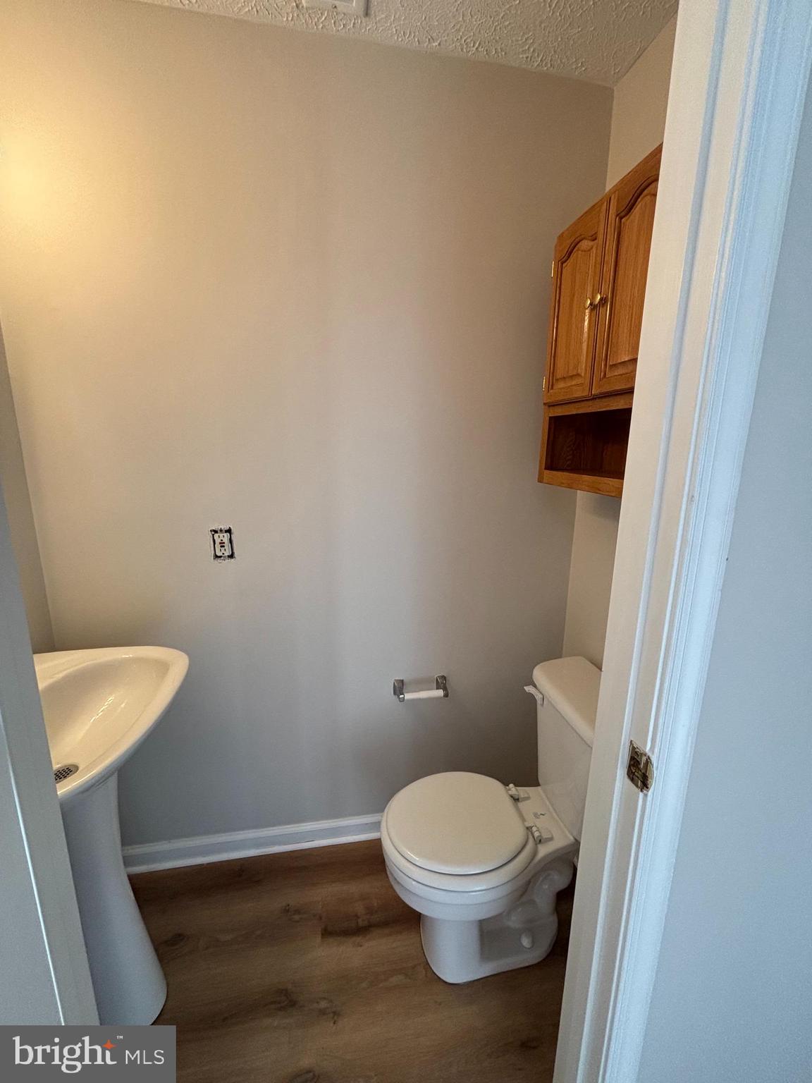 9804 Redwing Drive, Unit 9804 Perry Hall, MD 21128 - Photo 4 of 25 a white toilet sitting next to a bathroom sink