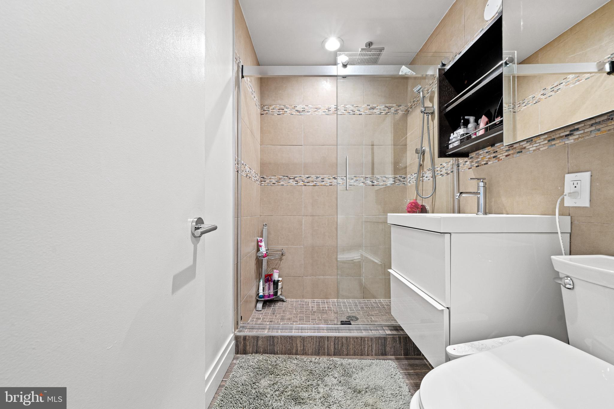 1674 Chimney House Road Reston, VA 20190 - Photo 24 of 39 a bathroom with a sink a toilet a shower and a mirror