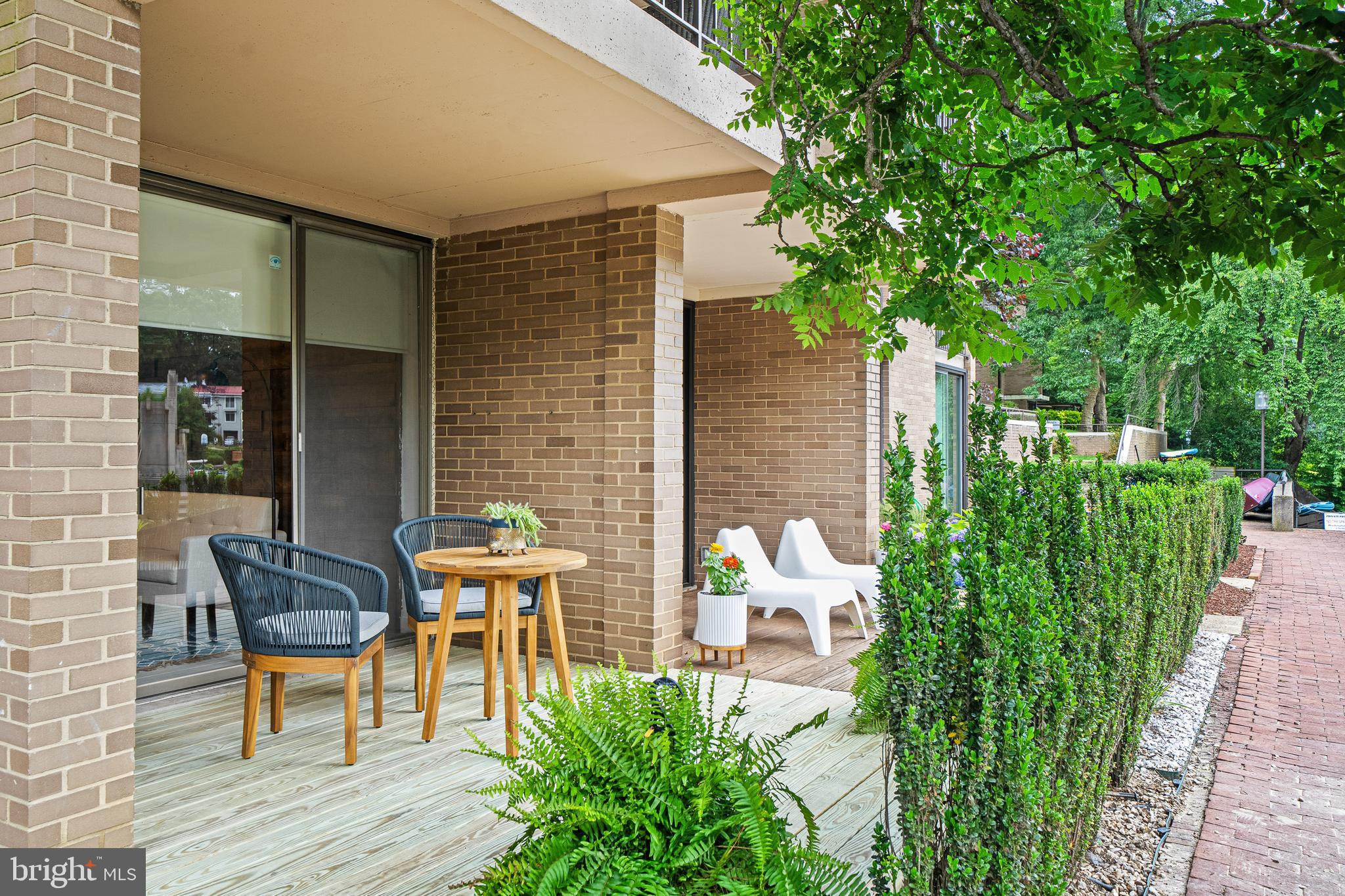1674 Chimney House Road Reston, VA 20190 - Photo 31 of 39 a view of a chair and tables in the patio with potted plants