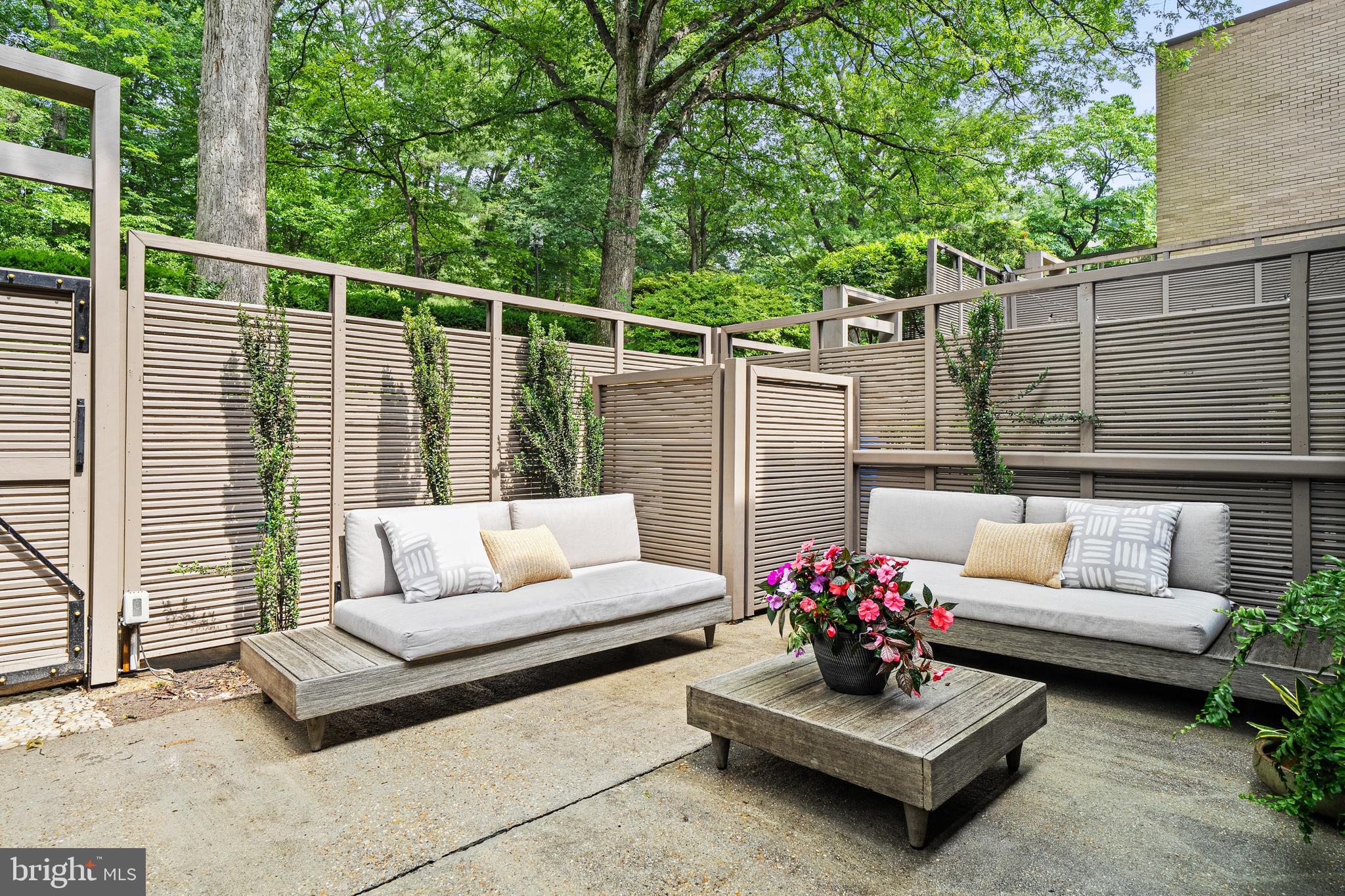 1674 Chimney House Road Reston, VA 20190 - Photo 6 of 39 a view of a patio with couches and a table and chairs with wooden floor