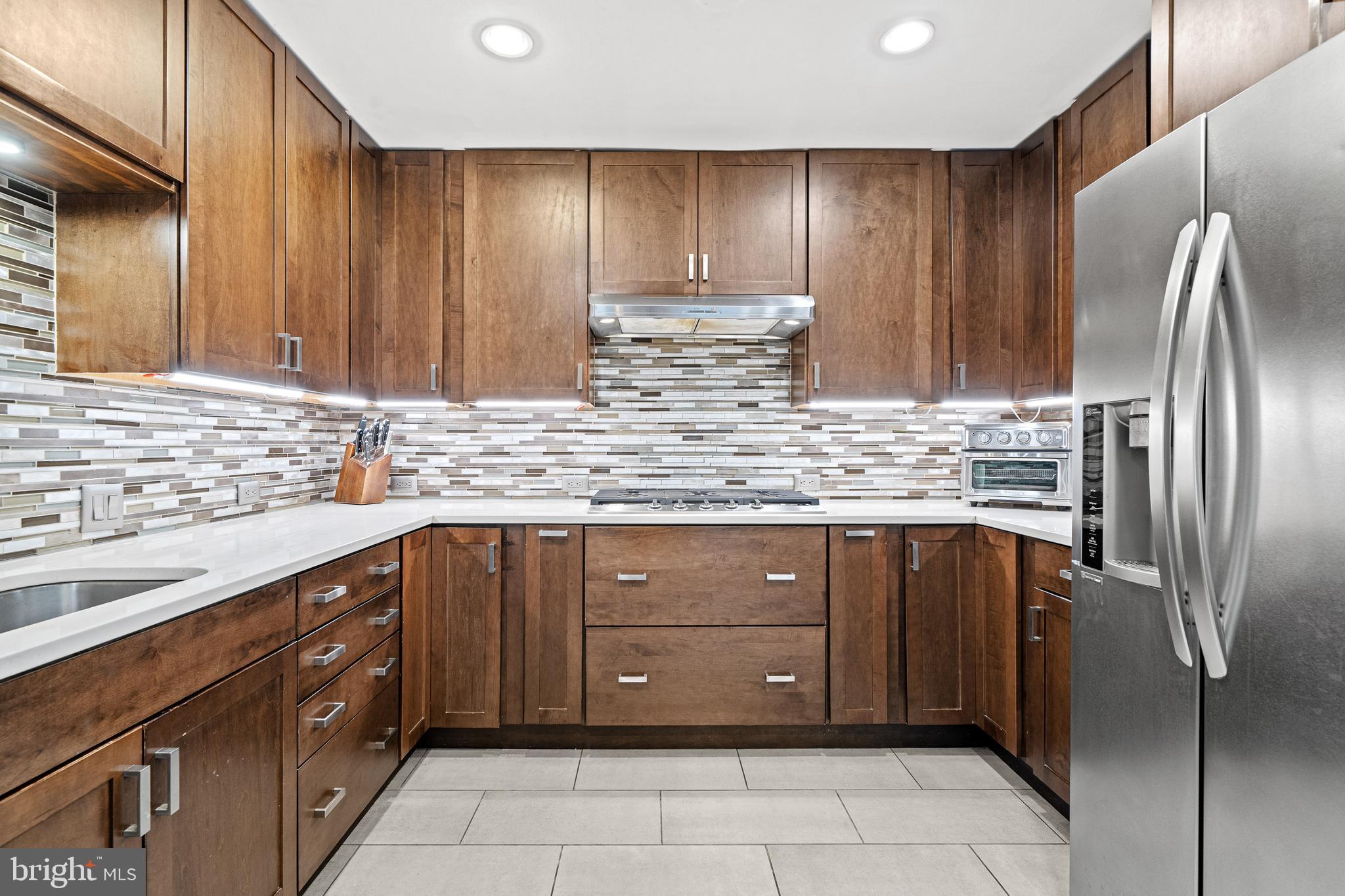 1674 Chimney House Road Reston, VA 20190 - Photo 10 of 39 a kitchen with stainless steel appliances granite countertop a refrigerator and a sink