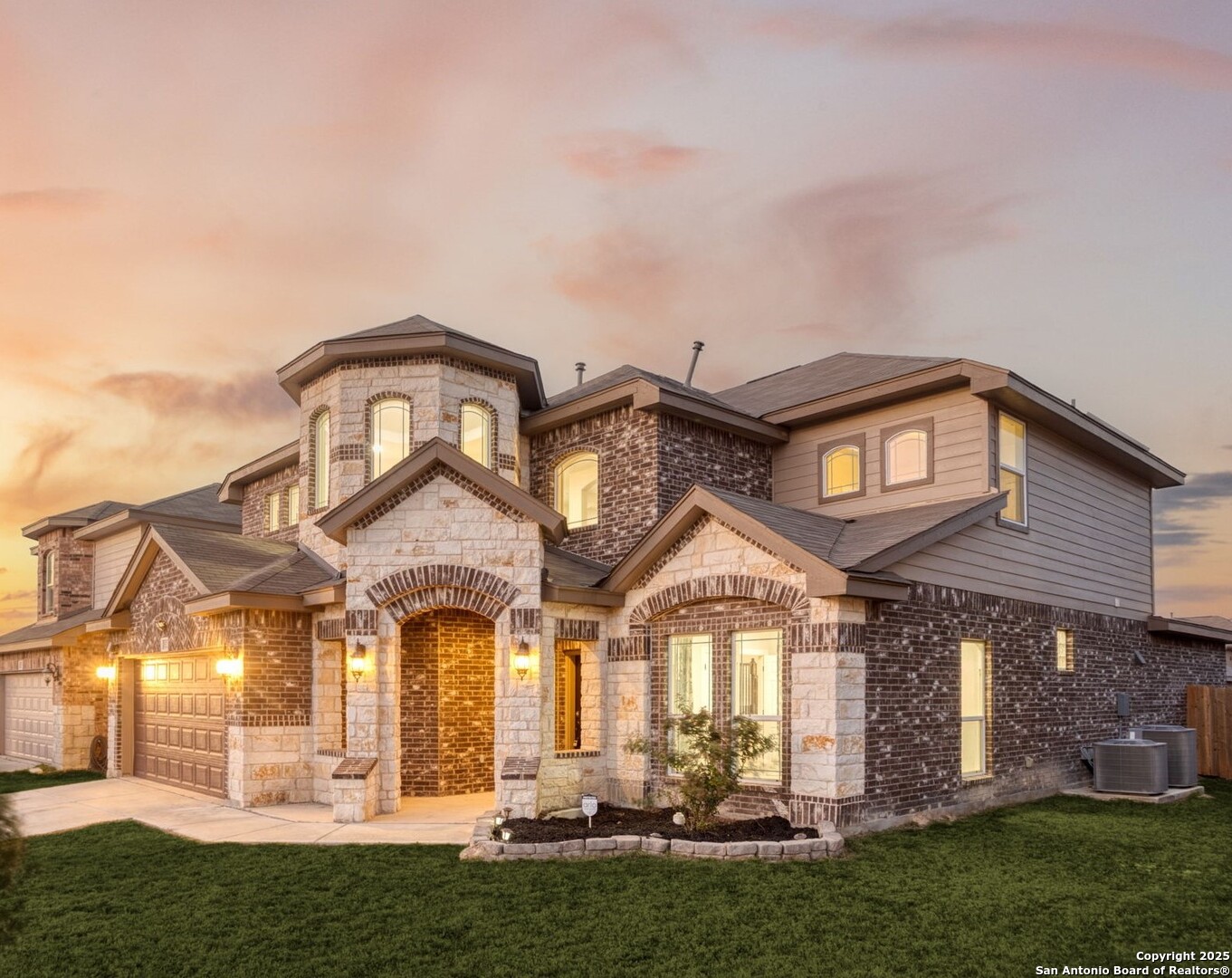 a front view of a house with a garden