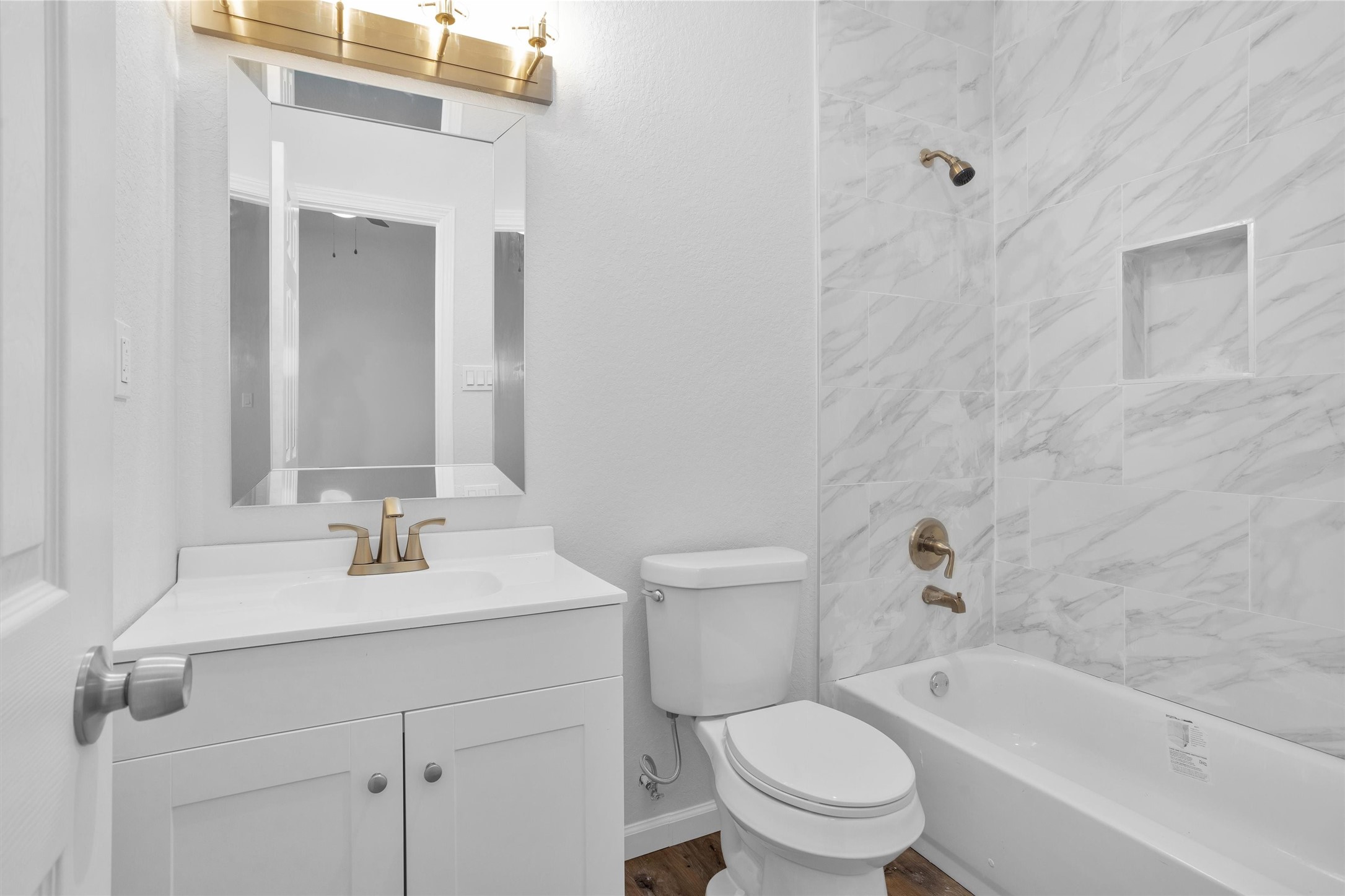 3916 Falls Street Houston, TX 77026 - Photo 11 of 28 a bathroom with a sink a toilet and a mirror