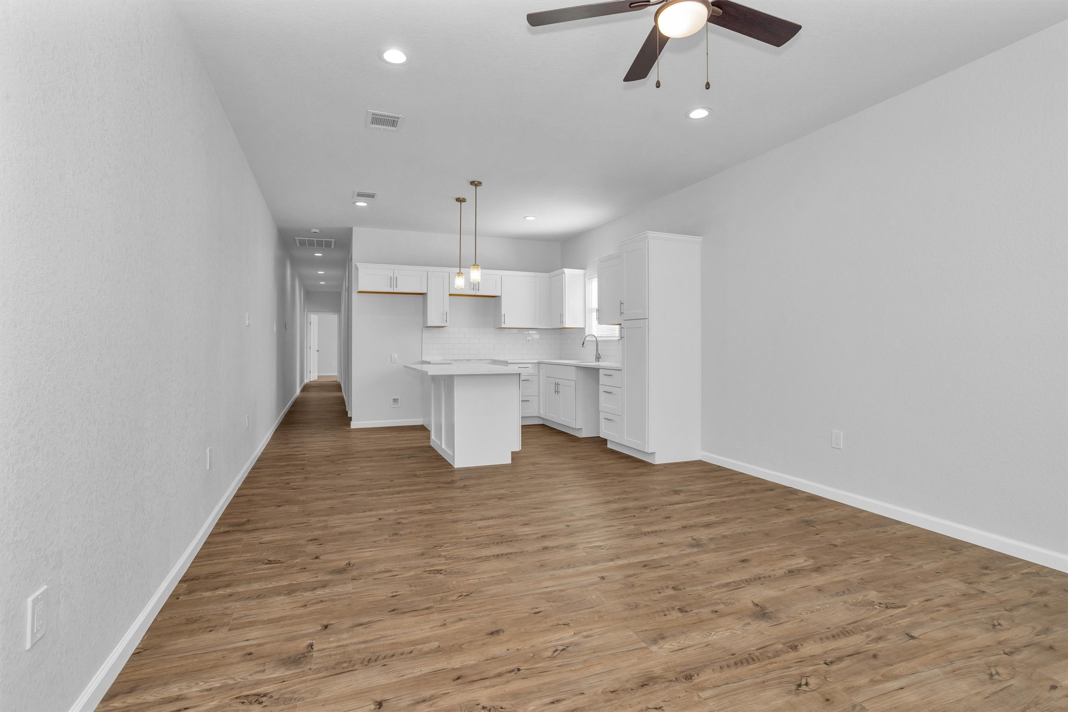 3916 Falls Street Houston, TX 77026 - Photo 18 of 28 an empty room with kitchen and chandelier fan