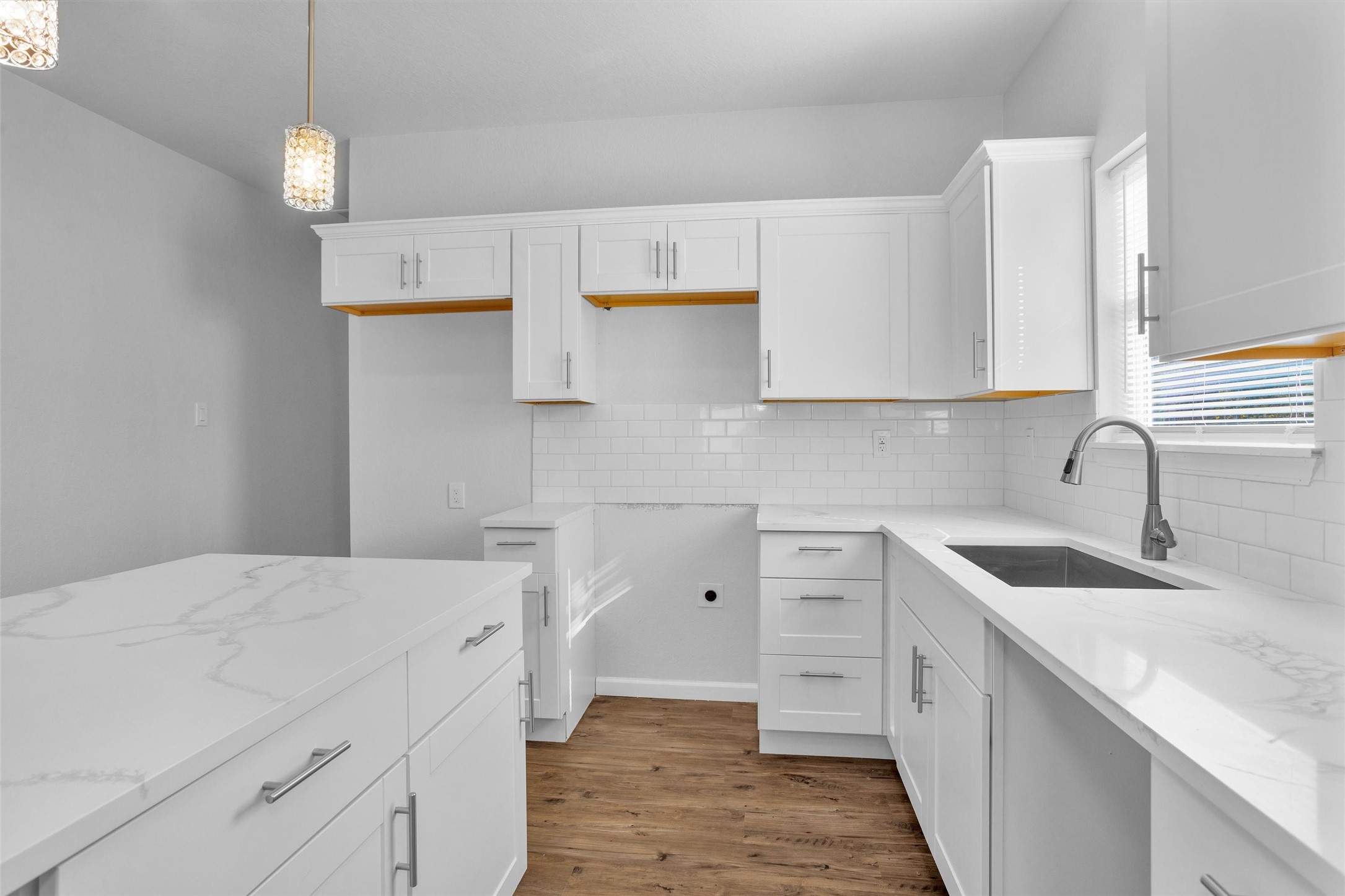 3916 Falls Street Houston, TX 77026 - Photo 20 of 28 a kitchen with a sink dishwasher and white cabinets