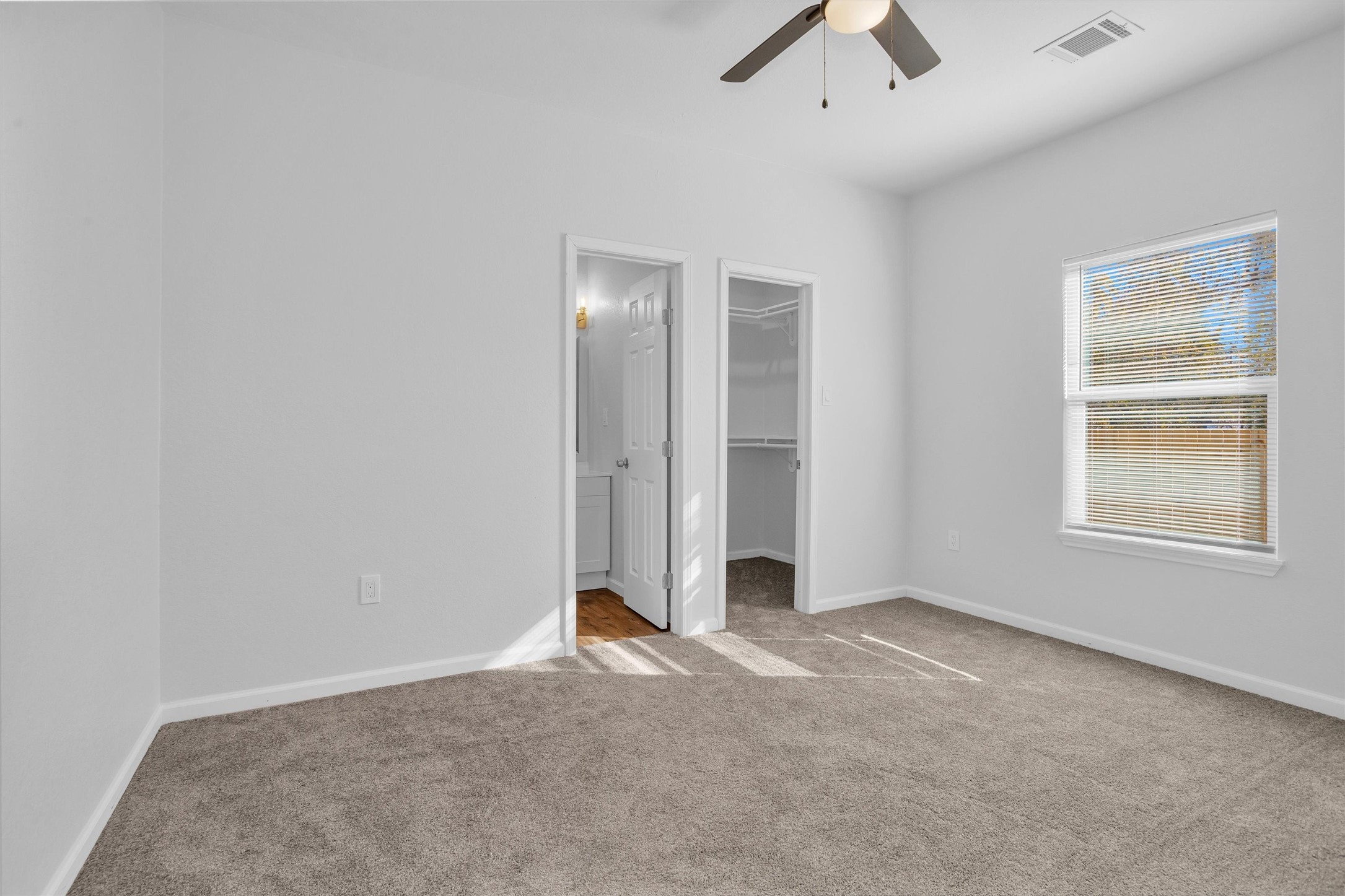 3916 Falls Street Houston, TX 77026 - Photo 21 of 28 an empty room with chandelier fan and windows