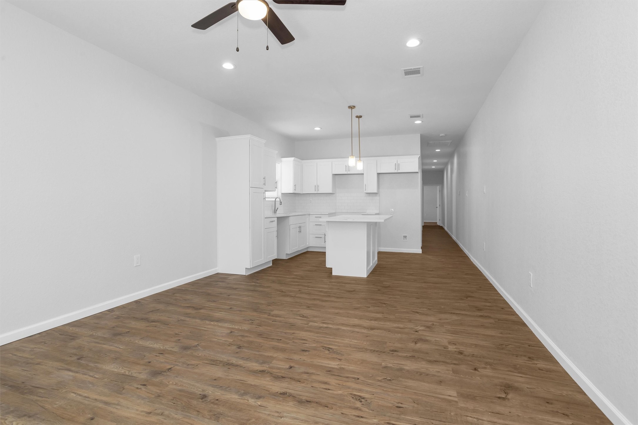 3916 Falls Street Houston, TX 77026 - Photo 4 of 28 wooden floor in an empty room with a kitchen