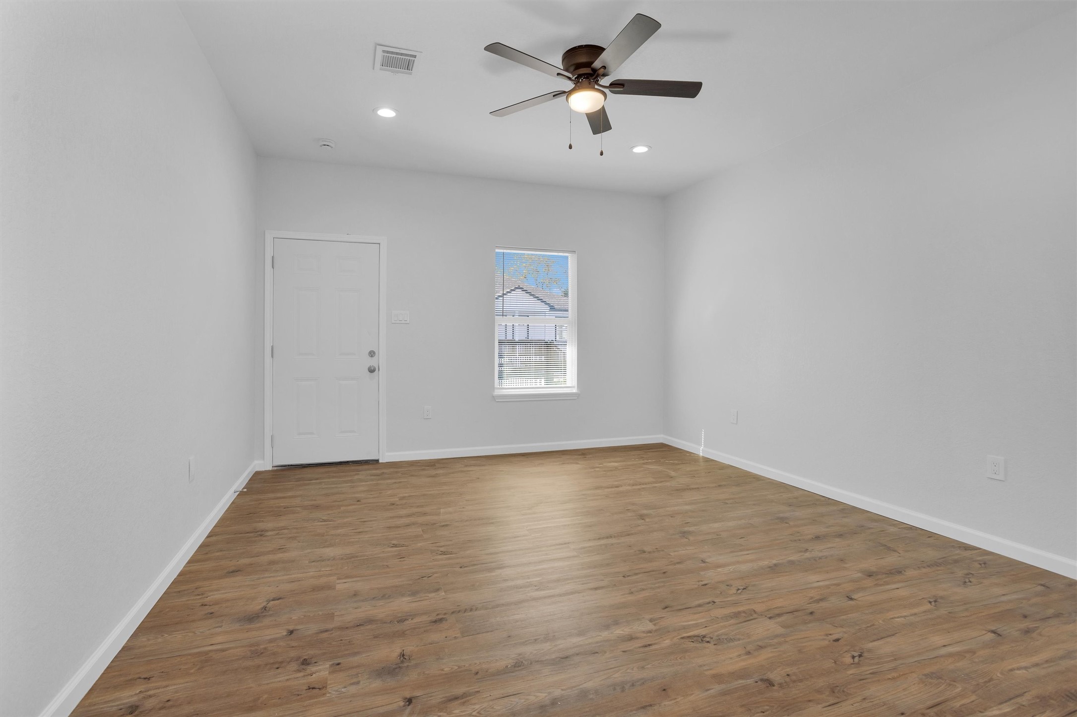 3916 Falls Street Houston, TX 77026 - Photo 5 of 28 a view of empty room with wooden floor and fan